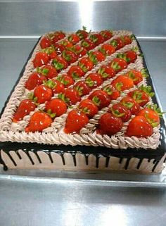 a cake with chocolate icing and strawberries on it