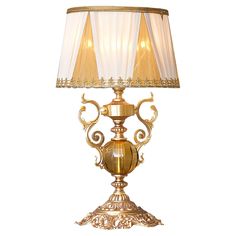 a gold lamp with a white shade on it