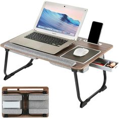 a laptop computer sitting on top of a wooden desk next to a mouse pad and cell phone