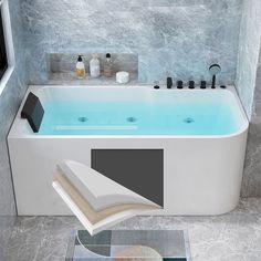 a bathroom with a bathtub and book on the floor