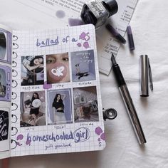 an open notebook with photos and pens on it