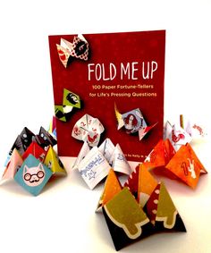 folded paper fortune tellers are displayed in front of a red book with the title fold me up