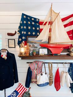 an american flag is hanging on the wall next to a coat rack and hat rack