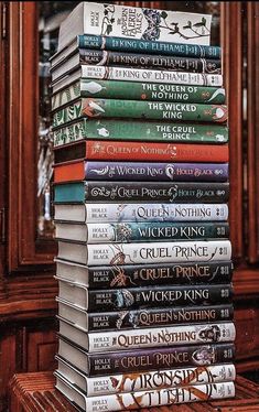 a stack of books sitting on top of a wooden table