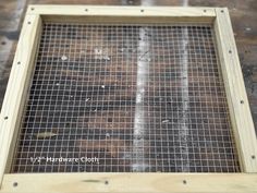 a close up of a metal screen on top of a wooden frame in the process of being constructed