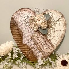 a wooden heart with flowers and music notes on it