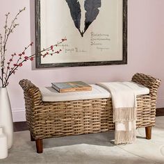 a wicker bench in front of a painting on the wall