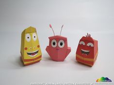 three origami toys with faces and eyes on them, one is yellow, the other is red