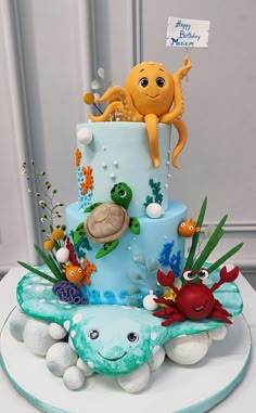 a three tiered cake decorated with sea animals