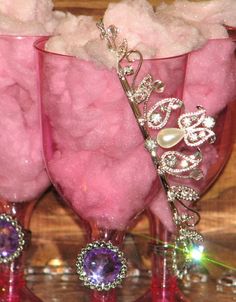 three wine glasses with pink stuff in them