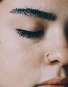 a close up of a person with freckles on their nose