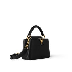 The refined capucines mini bag looks stunningly chic in rich black taurillon leather finished with golden handle rings and the emblematic lv initials. This smaller version of the classic capucines is a pleasure to carry over the shoulder or across the body, thanks to its removable strap. Luxury Handbags Aesthetic, Lv Capucines Mini, Lv Capucines Black, Mini Designer Bags, Louis Vuitton Mini Bag Louis Vuitton Official, Louis Vuitton Capucines Mini, Louis Vuitton Capucines Bb, Elegant Handbags