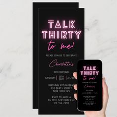 a hand holding up a phone next to a black and pink talk thirty birthday party card