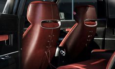 the interior of a car with red leather seats