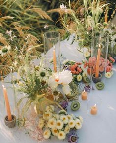 the table is set with flowers and candles