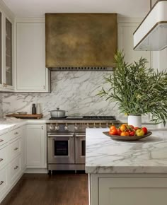 a kitchen with marble counter tops and white cabinets