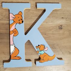 the letter k is painted with winnie the pooh characters