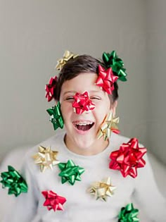 a young boy with christmas decorations on his face