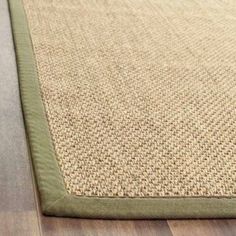 a close up view of a rug on the floor with wood floors in the background