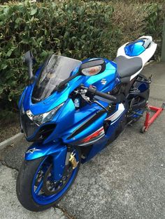 a blue and white motorcycle parked on the street