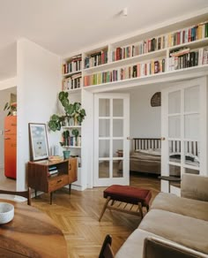 a living room filled with furniture and bookshelves