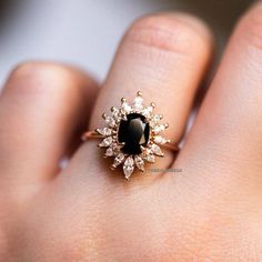 a woman's hand with a black and white diamond ring