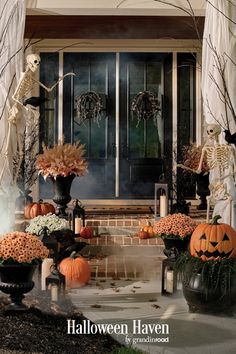 a front porch decorated for halloween with pumpkins and skeletons