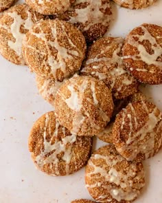 a pile of sugar covered cookies sitting on top of a white counter next to each other