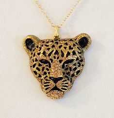 - Men's handsome Black Panther Head is adorned with sparkling Gold Rhinestones (Cubic Zirconia) to highlight his features in this awesome Pendant, or Necklace. Photos #1-5. - Black Panther Head now features a blush of Gold, making him even more striking. Lighting conditions can effect the richness of the Gold you see at times. - Pendant Head measures  2" Length, 1 7/8" Wide. - Pendant Drop is 2 1/2". - Stunning Gold Plated Brass Bail (hanger). - 20" Chain Length. - 14K Gold Filled 3mm Cable Chai Panther Head, Black Panthers, Gold Cross Pendant, Hammered Gold, Gold Rhinestone, Bright Gold, Beautiful Gift Boxes, Black Panther, Gold Gold