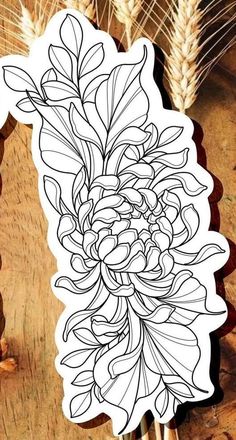 a sticker with an image of a flower and wheat stalks in it on a wooden table