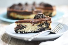 a piece of oreo cookie cheesecake on a plate with a fork next to it