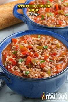 two blue bowls filled with meat and vegetables