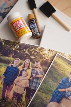 the family is posing for pictures on the table with their paintbrushes and paints