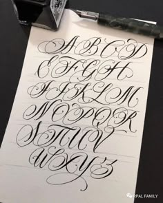 an ink pen and some type of calligraphy