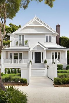 a large white house with lots of windows and balconies on the front porch