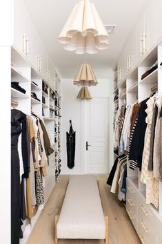 a walk in closet filled with lots of clothes