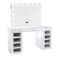 a white vanity table with drawers and a mirror on the wall above it is illuminated by lights