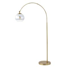 a gold floor lamp with a white ball on it