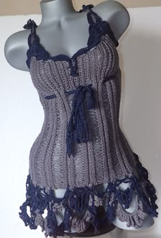 a woman's tank top with crochet on it