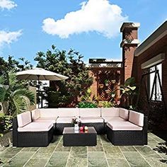 an outdoor living area with patio furniture and umbrellas