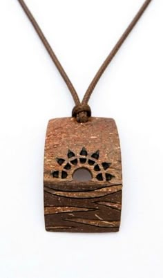 a wooden pendant with an animal's paw on it