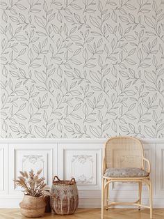 a chair and basket in front of a wallpapered room with white paneling