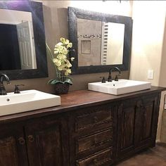 two sinks and mirrors in a bathroom with wood flooring