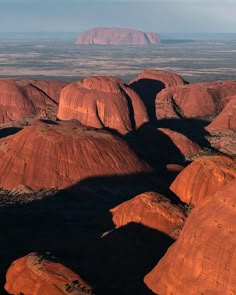 red rock formations in the desert with mountains in the background