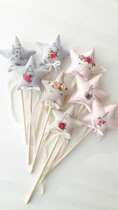 six star shaped lollipops with flowers on them sitting on a white surface