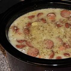 a crock pot filled with sausage and potatoes