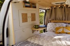 a bed in the back of a camper van