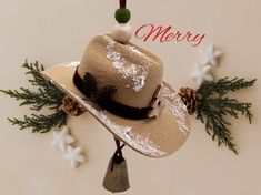 a merry hat with pine cones and snowflakes hanging from it's brim