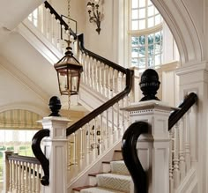 the stairs in this house have black and white railings