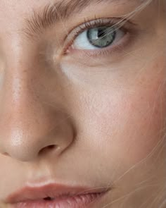 a woman with freckled hair and blue eyes